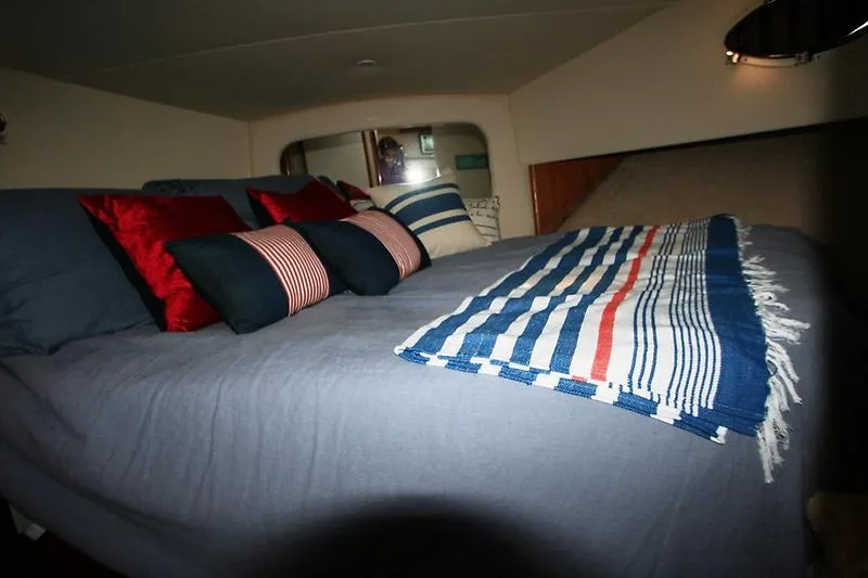 Slide: The Image of Interior cabin of 1999 Silverton 392 Motor Yacht with cozy bed and decorative pillows. - 22