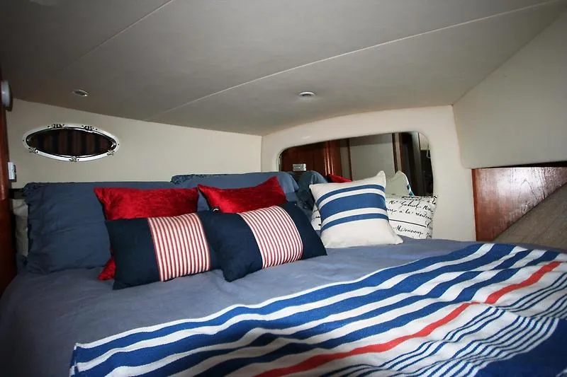 Slide: The Image of Cozy bedroom in 1999 Silverton 392 Motor Yacht with nautical-themed bedding. - 23
