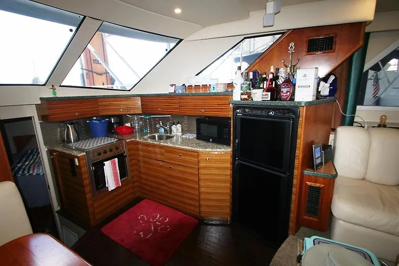 Slide: The Image of Interior of 1999 Silverton 392 Motor Yacht kitchen with wooden cabinets and appliances. - 30