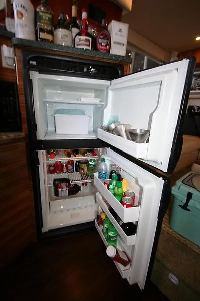 Slide: The Image of Open refrigerator in 1999 Silverton 392 Motor Yacht, stocked with beverages and food. - 33