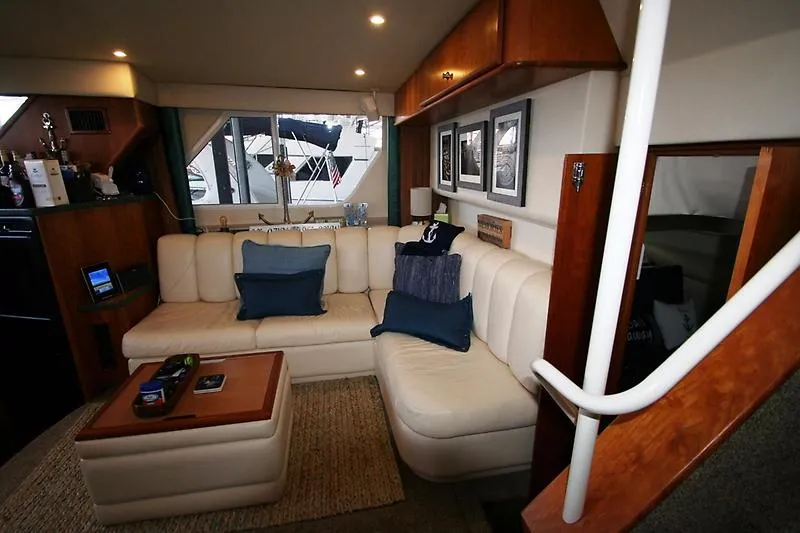 Slide: The Image of Interior of 1999 Silverton 392 Motor Yacht with beige leather seating and wooden accents. - 37