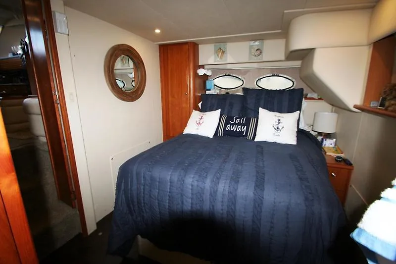Slide: The Image of Cozy bedroom in a 1999 Silverton 392 Motor Yacht with nautical decor. - 40