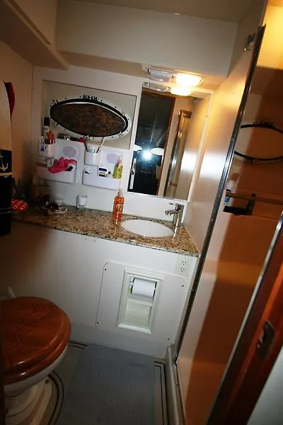 Slide: The Image of 1999 Silverton 392 Motor Yacht bathroom with granite countertop and oval mirror. - 41