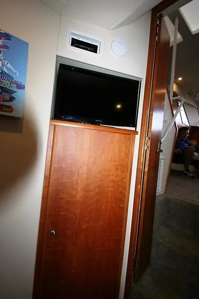 Slide: The Image of Interior of 1999 Silverton 392 Motor Yacht with TV and wooden cabinet. - 43