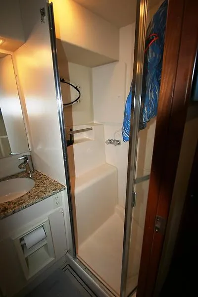 Slide: The Image of 1999 Silverton 392 Motor Yacht bathroom with shower and granite countertop sink. - 44