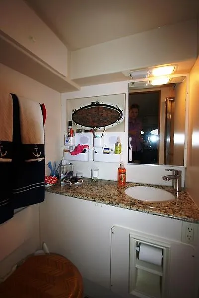 Slide: The Image of 1999 Silverton 392 Motor Yacht bathroom with granite countertop and nautical-themed towels. - 45