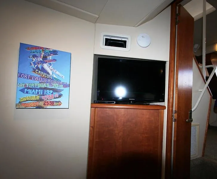 Slide: The Image of Interior of 1999 Silverton 392 Motor Yacht with TV and colorful wall art. - 46