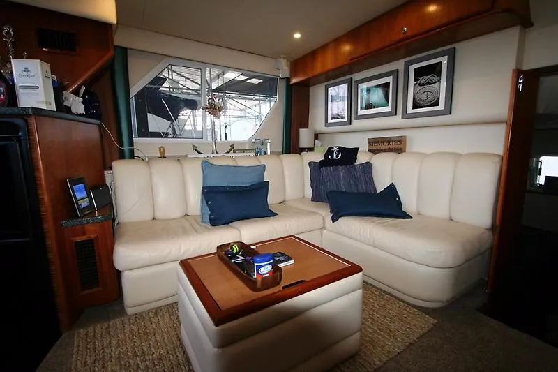 Slide: The Image of Interior of 1999 Silverton 392 Motor Yacht with white leather seating and nautical decor. - 48