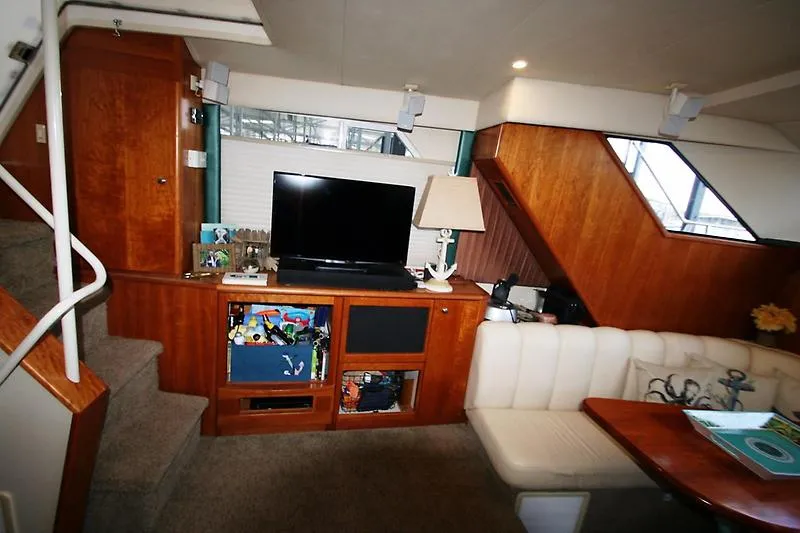 Slide: The Image of Interior of 1999 Silverton 392 Motor Yacht with TV, lamp, and seating area. - 49