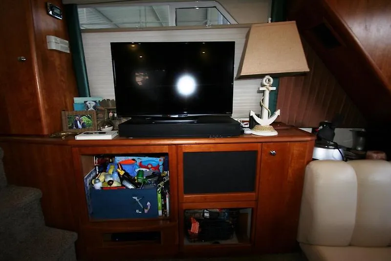 Slide: The Image of Entertainment center in 1999 Silverton 392 Motor Yacht with TV, lamp, and storage compartments. - 50