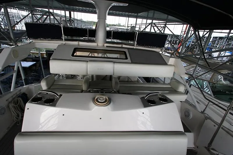 Slide: The Image of 1999 Silverton 392 Motor Yacht helm station with seating and controls. - 7