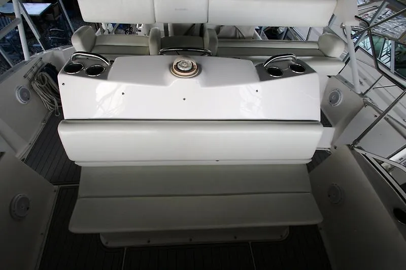 Slide: The Image of 1999 Silverton 392 Motor Yacht helm station with seating and steering wheel. - 8