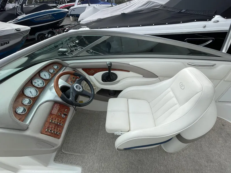 Slide: The Image of Interior of a 2005 Cobalt 240 boat with white seat and dashboard. - 14
