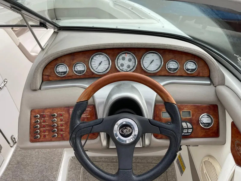 Slide: The Image of Dashboard of a 2005 Cobalt 240 boat with wood paneling. - 15