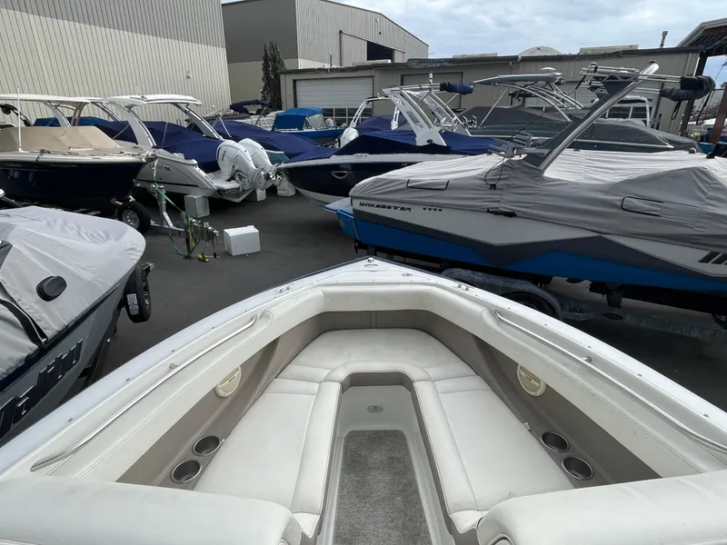 Slide: The Image of 2005 Cobalt 240 boat in a marina with other boats. - 16