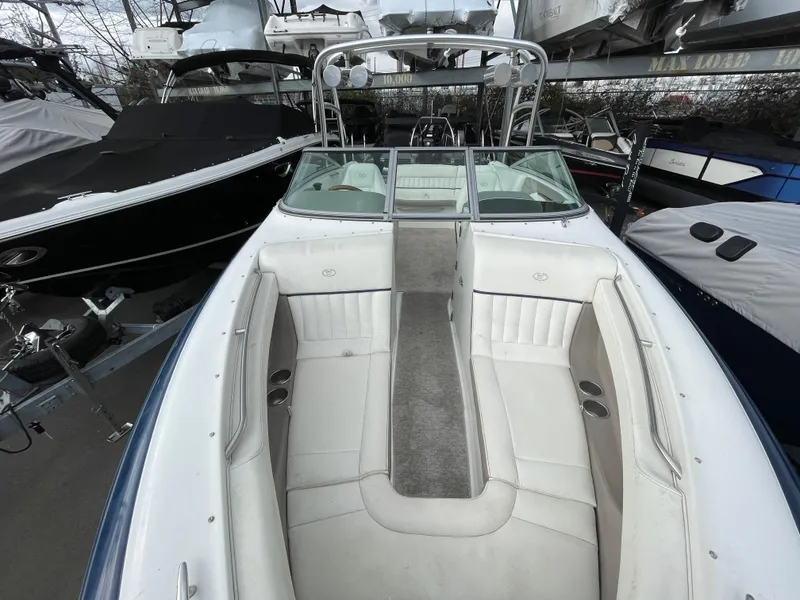 Slide: The Image of 2005 Cobalt 240 boat with white interior in marina. - 17