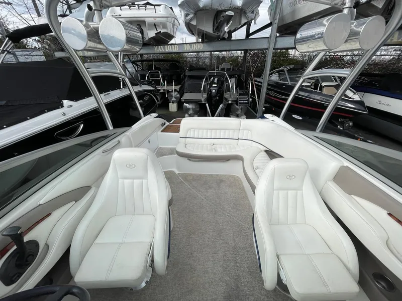 Slide: The Image of Interior of a 2005 Cobalt 240 boat with white leather seats. - 18