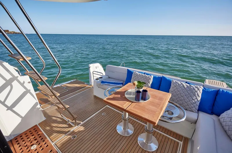 Slide: The Image of Luxurious 2024 Beneteau Antares 12 yacht deck with ocean view and elegant seating area. - 10