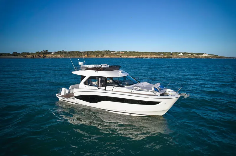 Slide: The Image of 2024 Beneteau Antares 12 yacht cruising on open water under clear blue skies. - 3