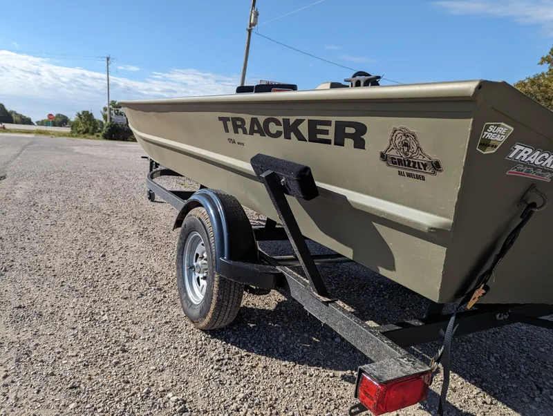 Slide: The Image of 2024 Tracker Grizzly 1754 SC boat on a trailer in a parking lot. - 4