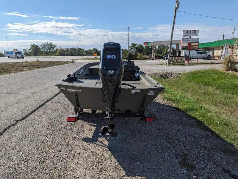 Slide: The Image of 2024 Tracker Grizzly 1754 SC boat with 60 HP Mercury engine on a gravel road. - 5