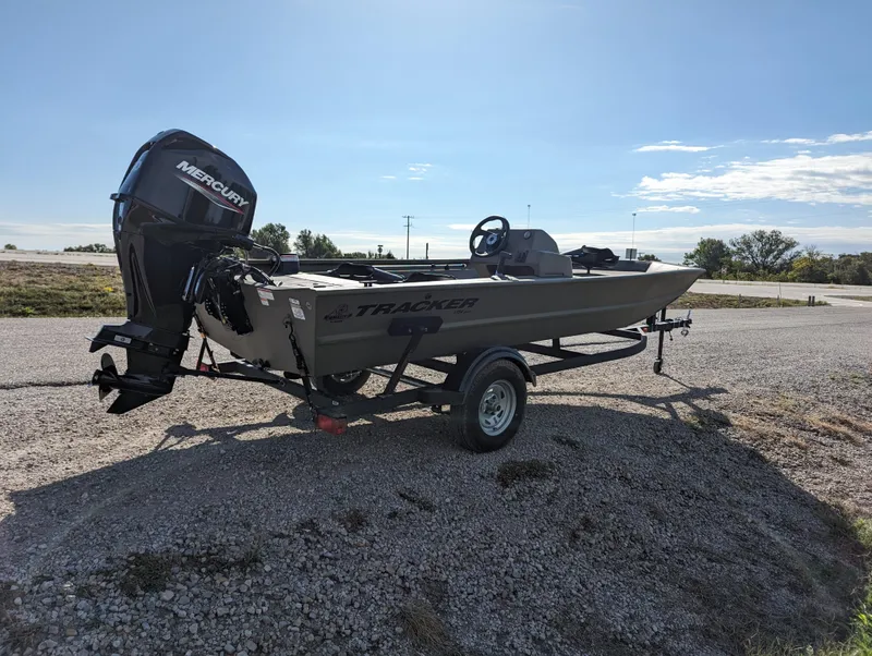 Slide: The Image of 2024 Tracker Grizzly 1754 SC boat with Mercury outboard motor on trailer. - 7