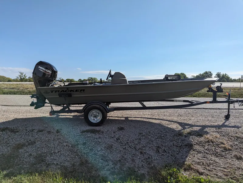 Slide: The Image of 2024 Tracker Grizzly 1754 SC boat on trailer under clear sky. - 8