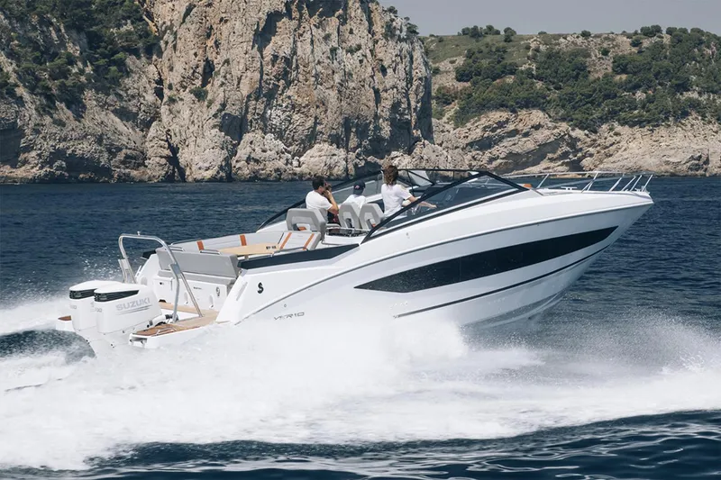 Slide: The Image of 2024 Beneteau Flyer 10 boat cruising near rocky coastline with passengers onboard. - 3