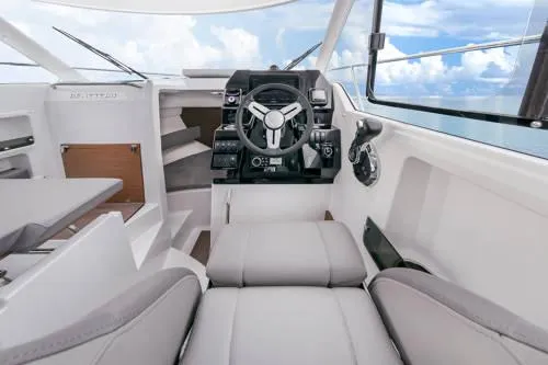 Slide: The Image of 2024 Beneteau Antares 8 V2 interior, featuring modern helm and seating with ocean view. - 6