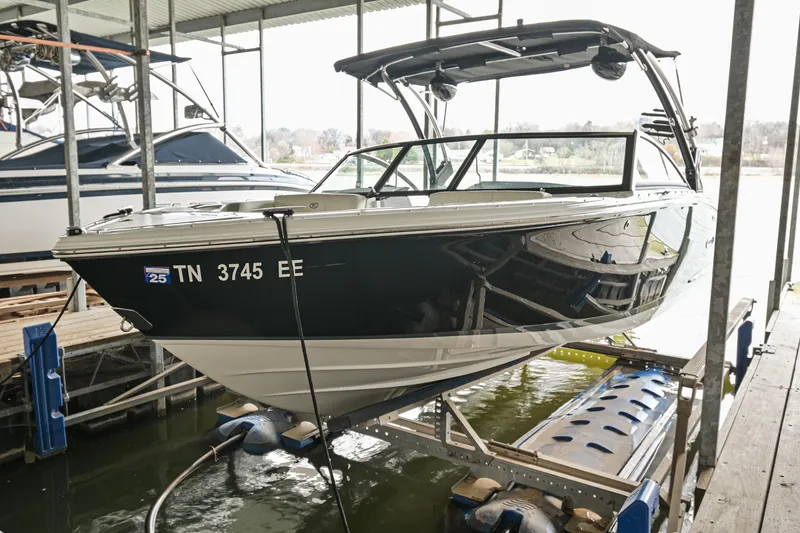 The Image of 2020 Cobalt CS23 boat docked on a lift in a marina. - 0