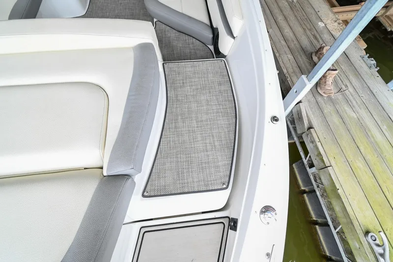 Slide: The Image of 2020 Cobalt CS23 boat interior with cushioned seating and deck mat. - 11