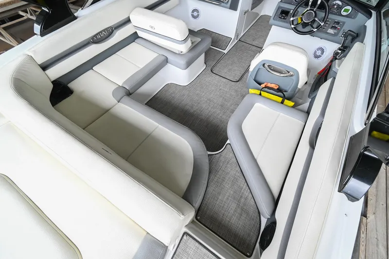 Slide: The Image of 2020 Cobalt CS23 boat interior with white and gray seating and modern dashboard. - 15