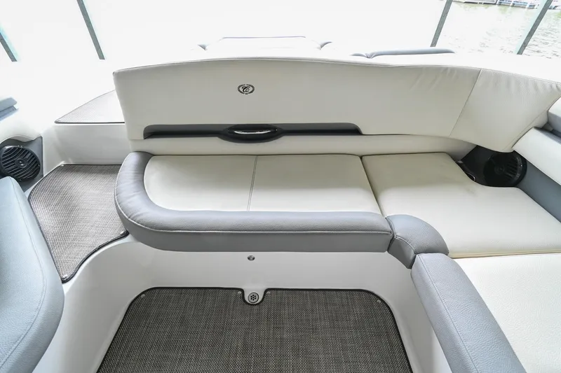 Slide: The Image of 2020 Cobalt CS23 boat interior with cushioned seating and carpeted flooring. - 20