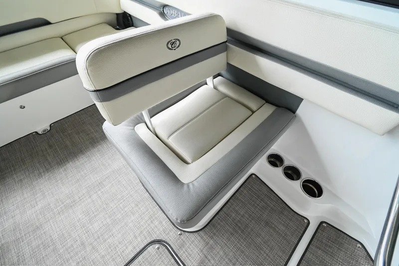 Slide: The Image of 2020 Cobalt CS23 boat interior with cushioned seating and cup holders. - 28