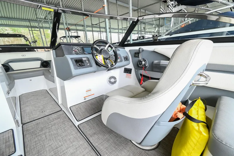 Slide: The Image of 2020 Cobalt CS23 boat interior with captain's seat and dashboard. - 29