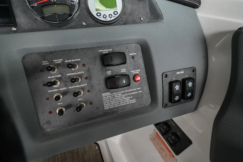 Slide: The Image of Control panel of a 2020 Cobalt CS23 boat with various switches and gauges. - 32