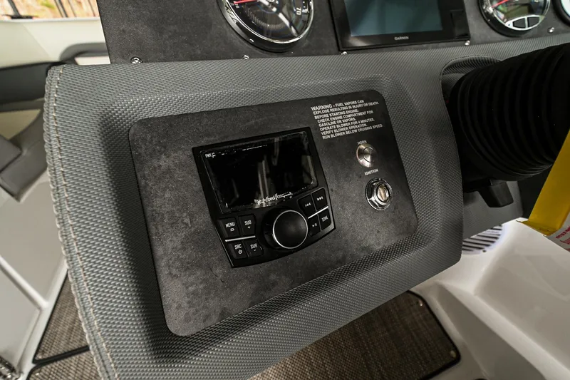 Slide: The Image of Control panel of a 2020 Cobalt CS23 boat with stereo system and gauges. - 34