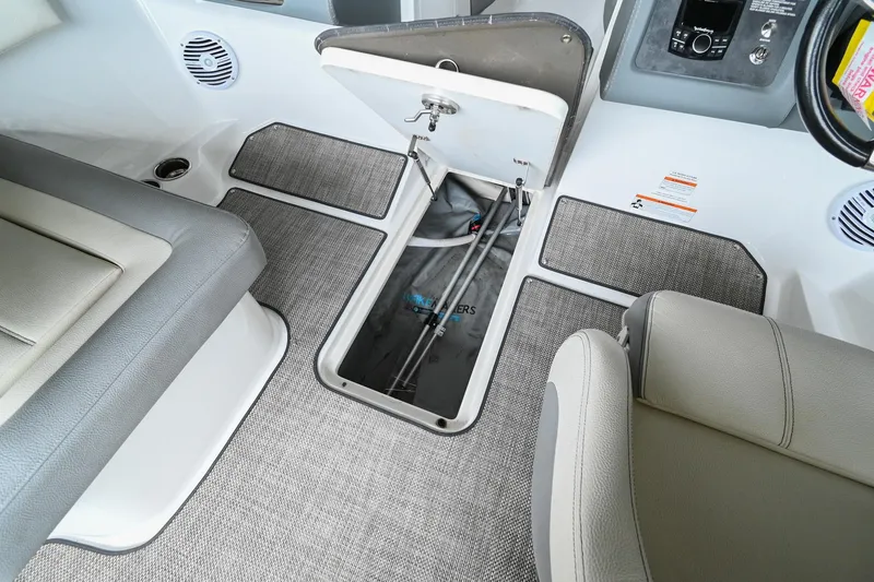 Slide: The Image of 2020 Cobalt CS23 boat interior storage compartment with open hatch. - 35