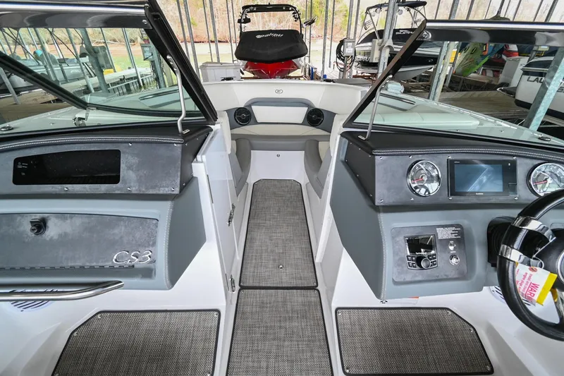 Slide: The Image of 2020 Cobalt CS23 boat interior with dashboard and steering wheel. - 36
