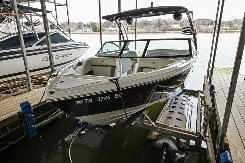 Slide: The Image of 2020 Cobalt CS23 boat docked in a marina. - 4
