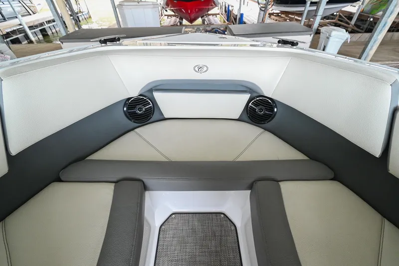 Slide: The Image of 2020 Cobalt CS23 boat interior with cushioned seating and built-in speakers. - 42