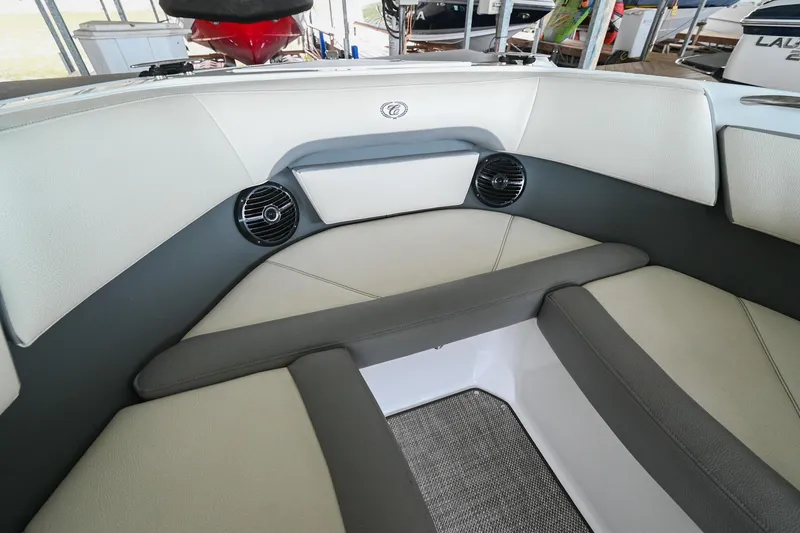 Slide: The Image of 2020 Cobalt CS23 boat interior with cushioned seating and built-in speakers. - 43