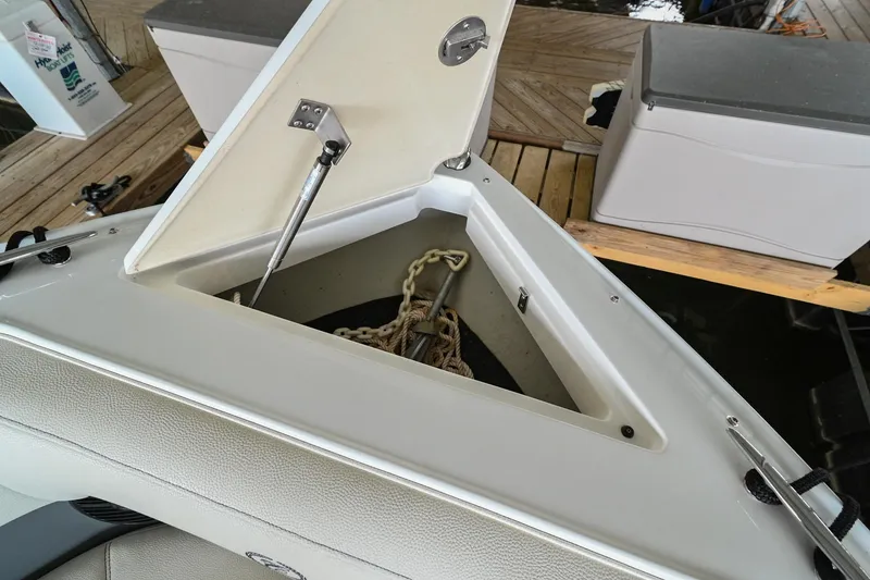 Slide: The Image of Open anchor storage compartment on a 2020 Cobalt CS23 boat. - 44