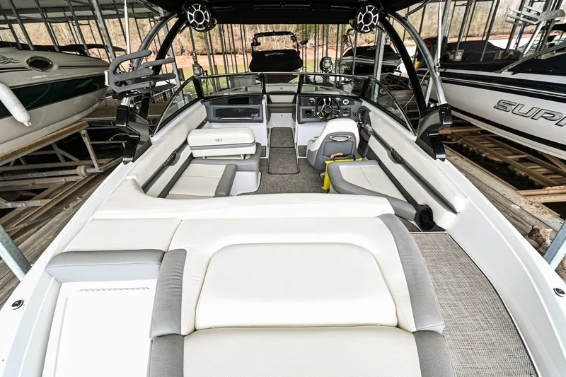 Slide: The Image of 2020 Cobalt CS23 boat interior with spacious seating and modern dashboard. - 6
