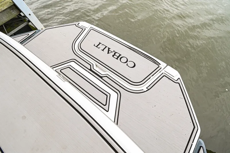 Slide: The Image of 2020 Cobalt CS23 boat swim platform by the water. - 8