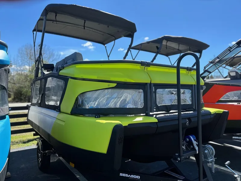 The Image of 2024 Sea-Doo SWITCH CRUISE 21FT 230HP pontoon boat in bright yellow on a trailer. - 1
