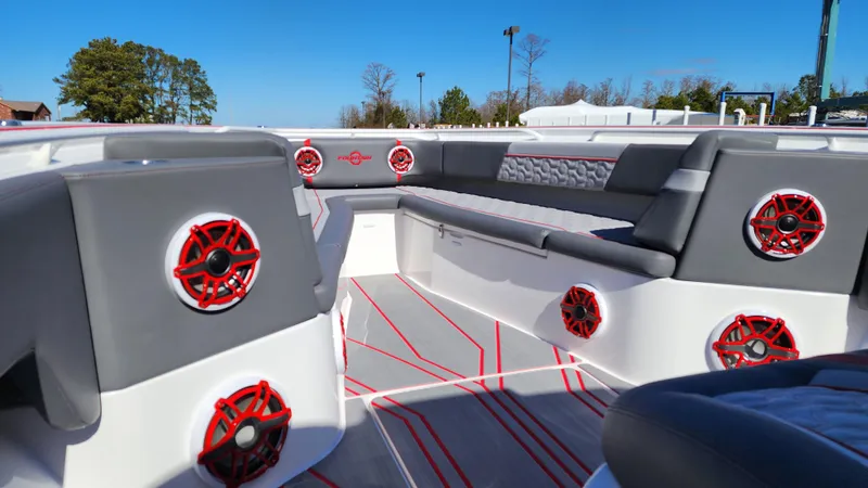 Slide: The Image of 2024 Fountain 38 SC boat interior with red speakers and gray seating. - 10