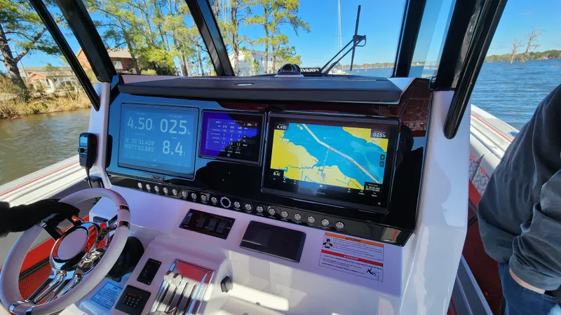 Slide: The Image of 2024 Fountain 38 SC boat dashboard with navigation and control systems. - 15