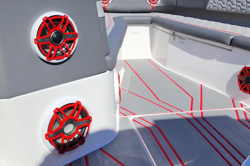 Slide: The Image of 2024 Fountain 38 SC boat interior with red speakers and grey seating. - 20
