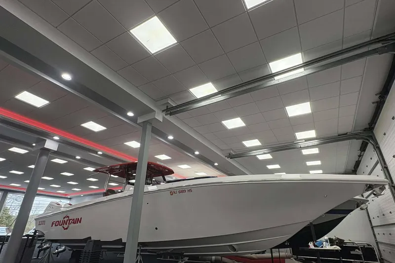 Slide: The Image of 2024 Fountain 38 SC boat displayed indoors under bright ceiling lights. - 25
